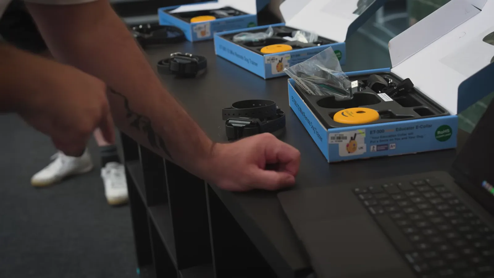 Wearable challenge devices and their boxes shown in the WARDOGS livestream announcement